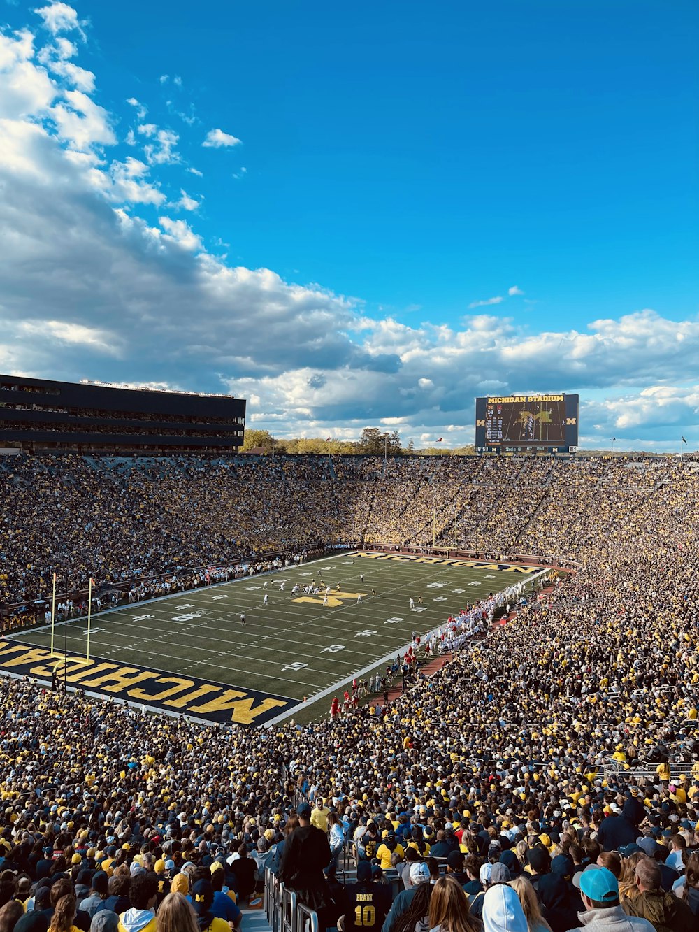 a football stadium full of fans and a football field