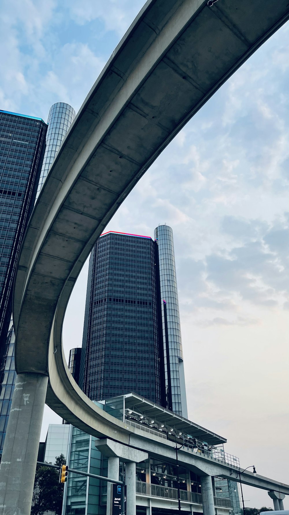 a very tall building next to a very tall bridge