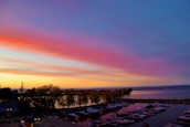 A serene view of boats docked at a marina during sunset.