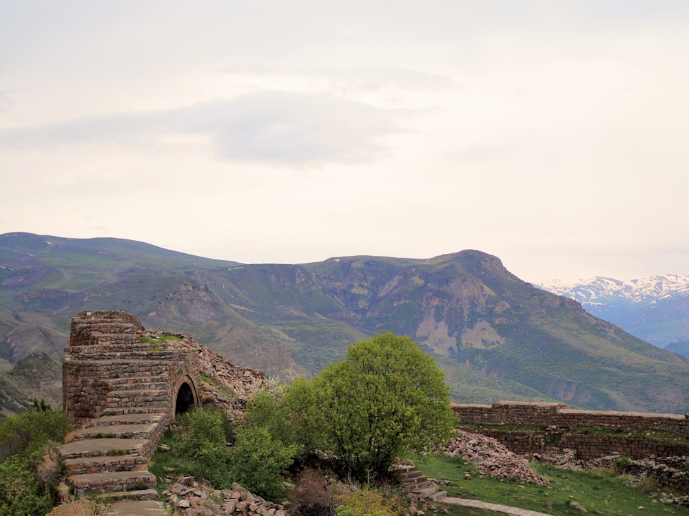 a stone structure in the middle of a mountain range