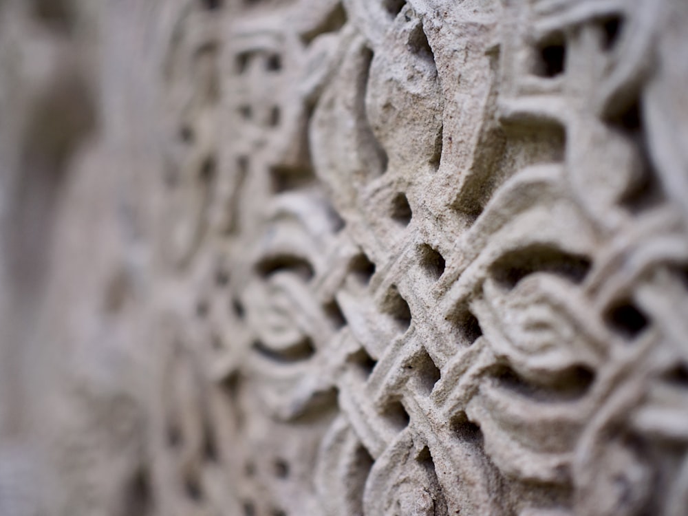 a close up of a stone wall with a pattern on it