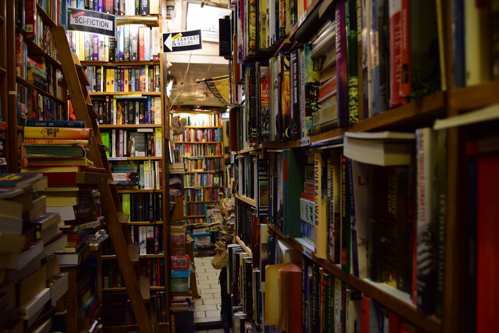 a narrow bookshelf filled with lots of books