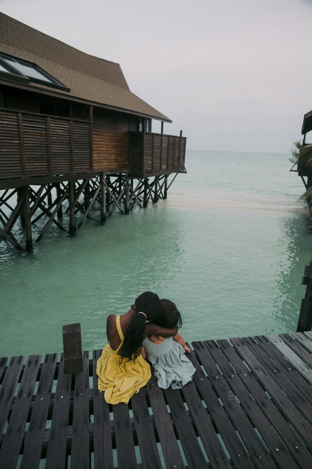 a couple of people that are sitting on a dock