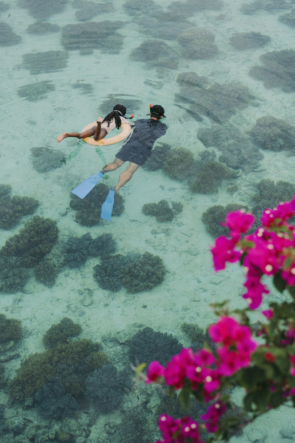 a couple of people in the water with skis