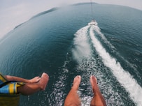 a man riding a jet ski while being pulled by a boat