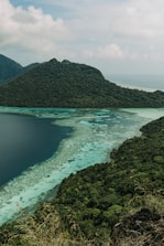 a body of water surrounded by mountains and trees
