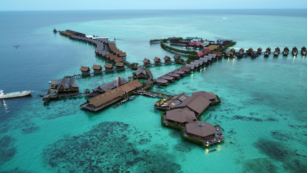 an aerial view of a resort in the middle of the ocean