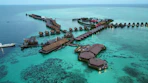 an aerial view of a resort in the middle of the ocean