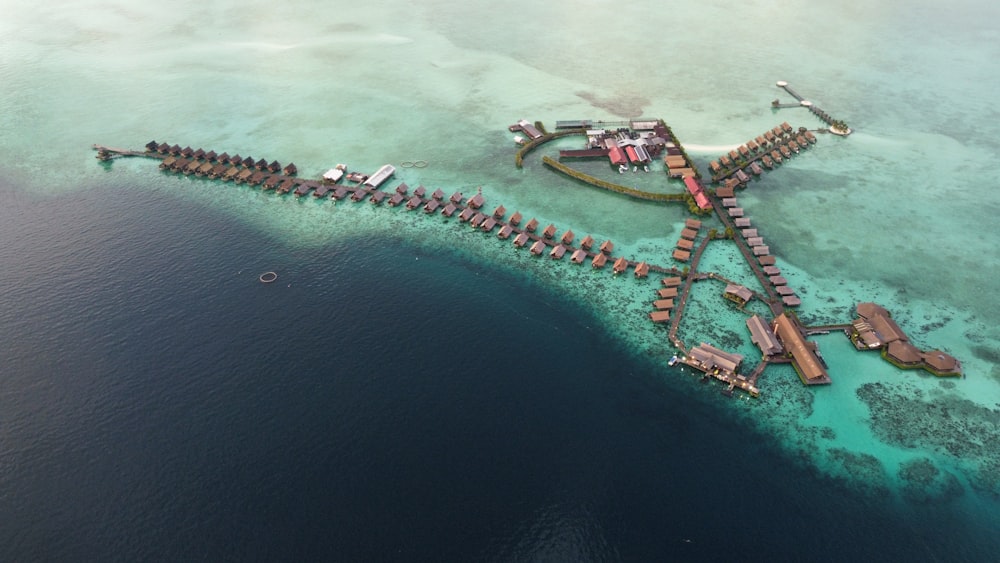 an aerial view of a resort in the middle of the ocean