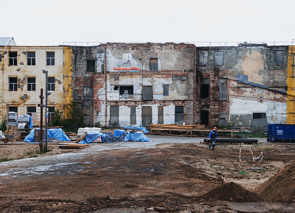 an old building with a lot of blue tarps