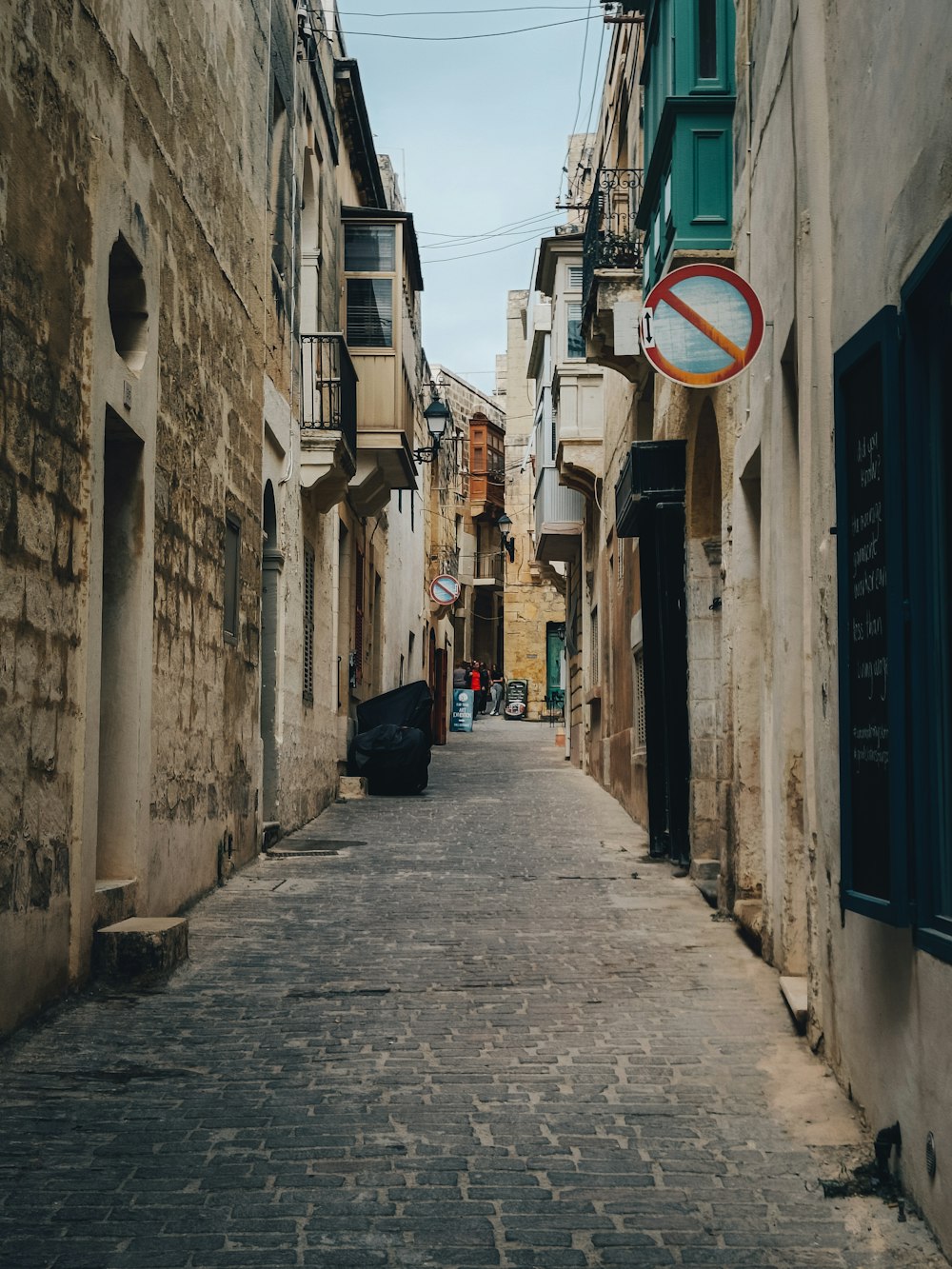 a street with a sign hanging from the side of it