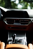 A close-up of a car's dashboard with clean, modern design and controls.