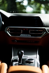 A close-up of a sleek Japanese car dashboard showcasing modern controls and design.