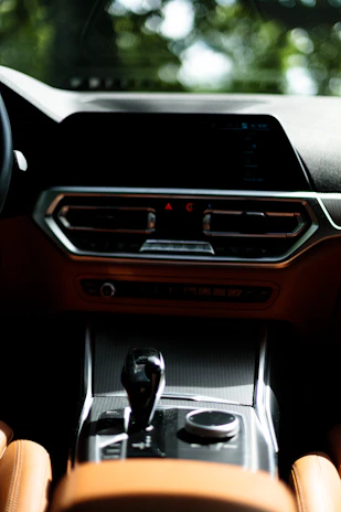 Close-up of a sleek Japanese car dashboard showcasing modern features and craftsmanship.