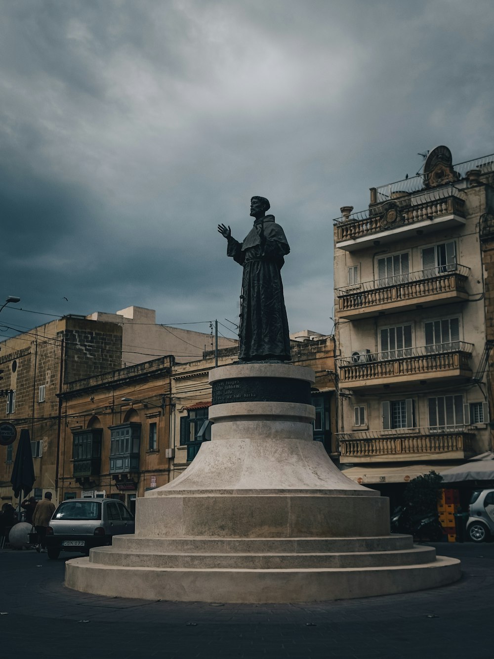 a statue of a woman in a city square