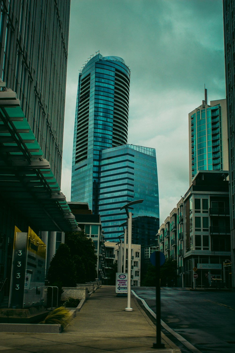 a city street with tall buildings in the background