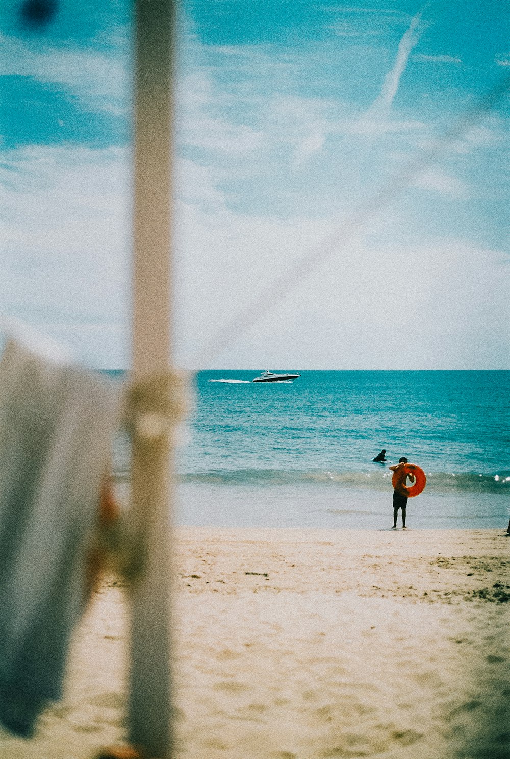 a person holding a surfboard on a beach