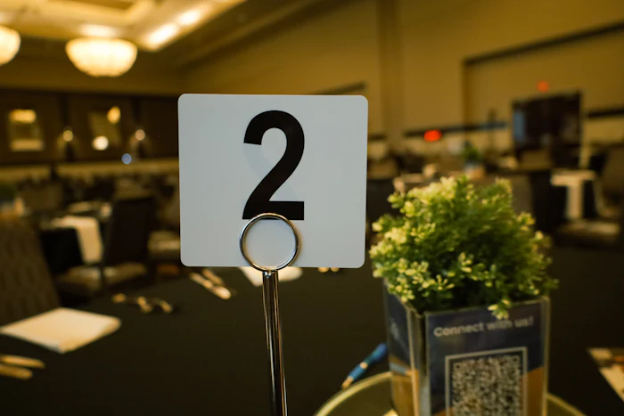 A table number card beside a plant