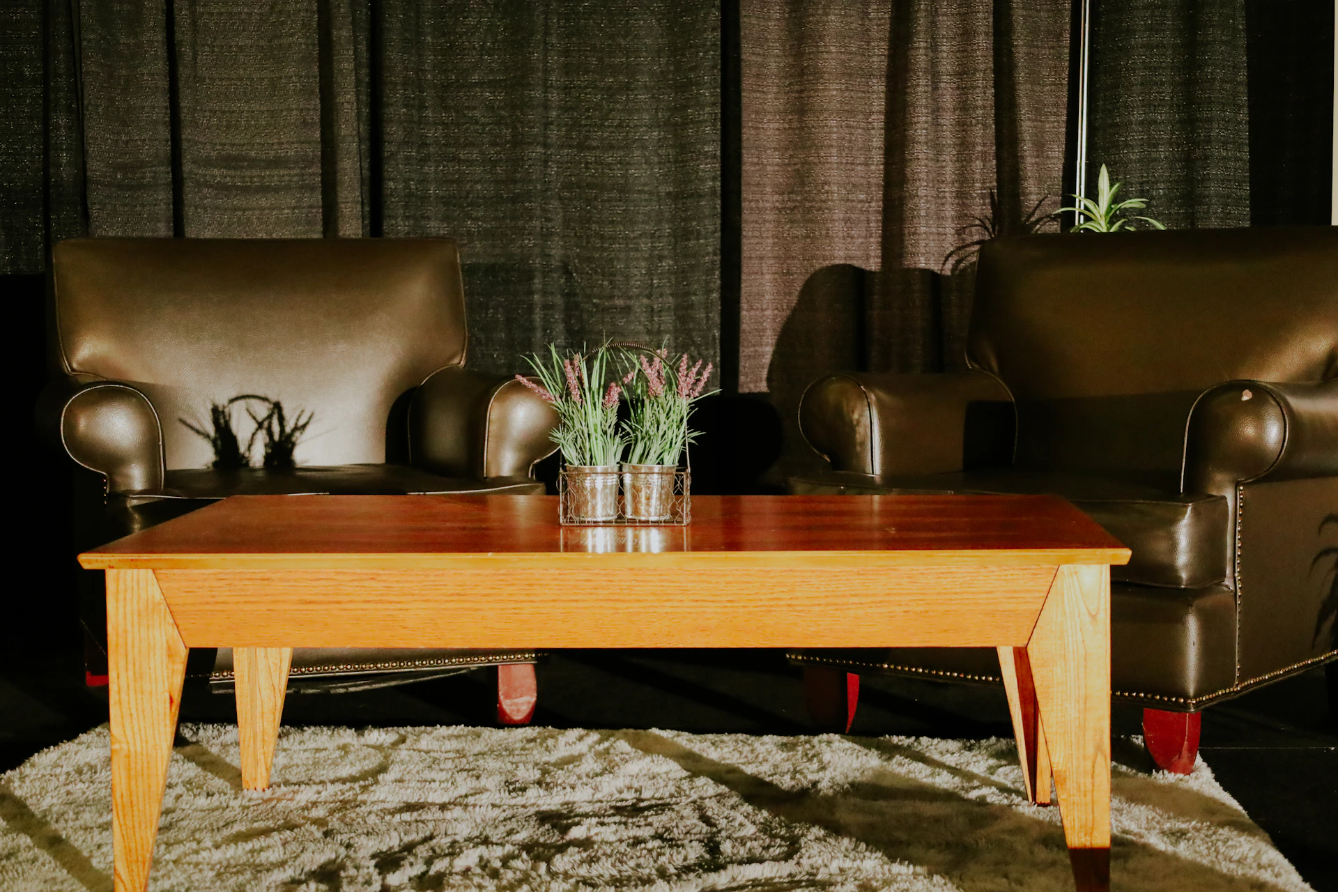 a living room with a coffee table and two chairs