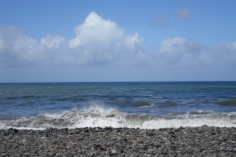 a view of the ocean from a rocky beach