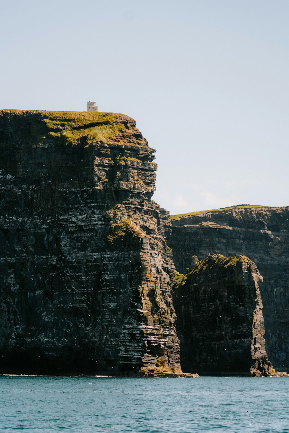 a large rock outcropping in the middle of a body of water