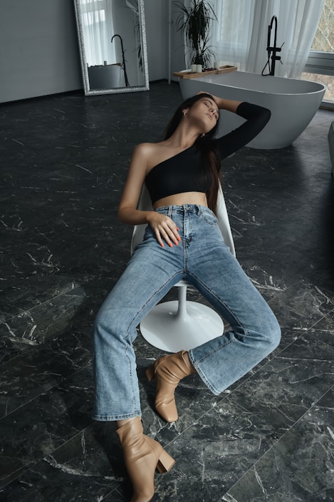 a woman sitting on a chair in a bathroom