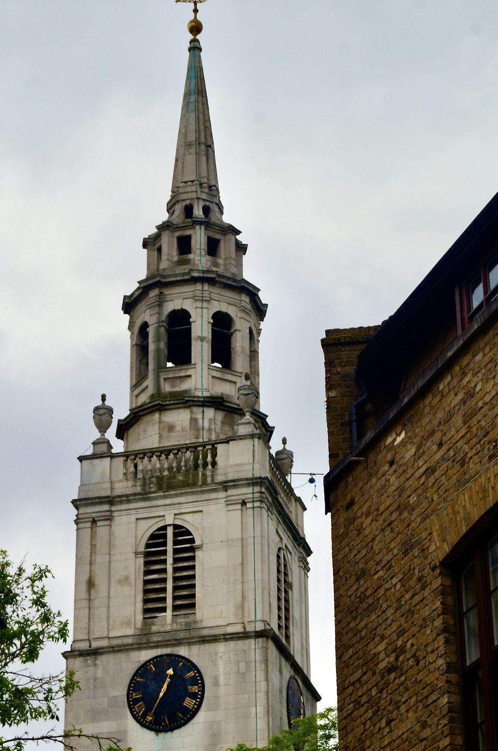 a tall clock tower with a clock on each of it's sides