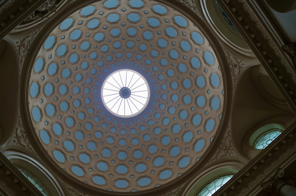 the ceiling of a building with a circular window