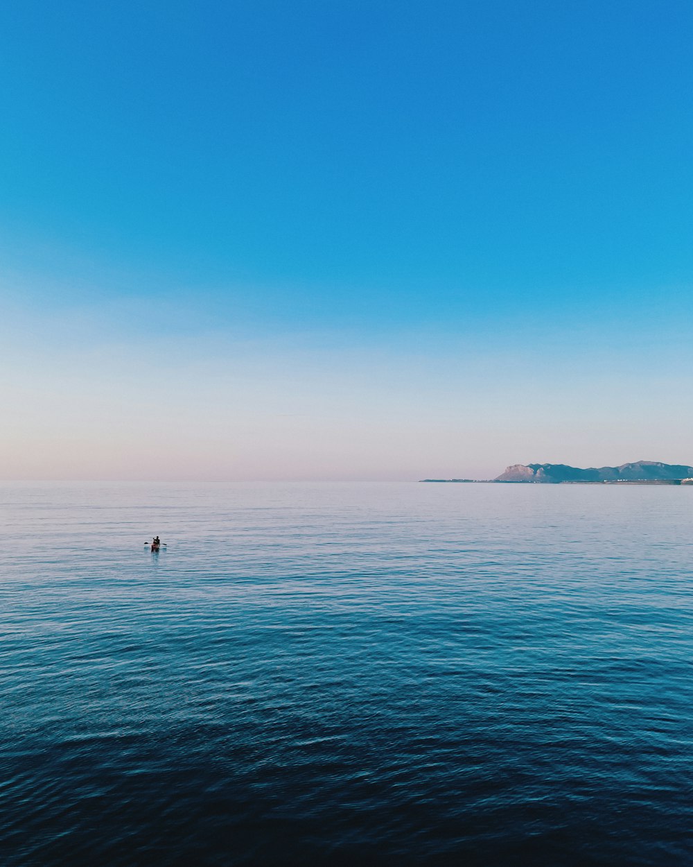 a lone person in the middle of the ocean