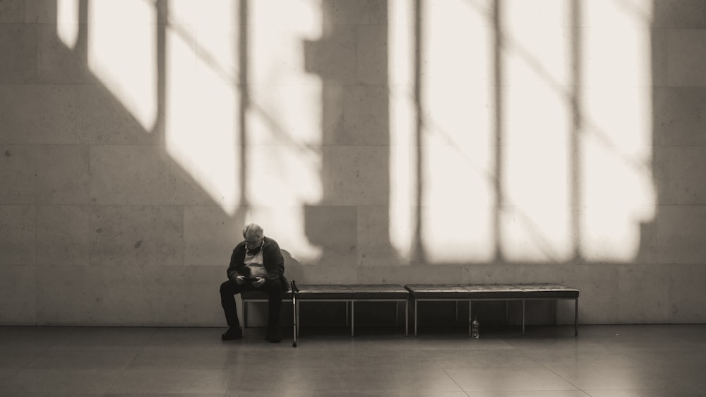 a man sitting on a bench in a building