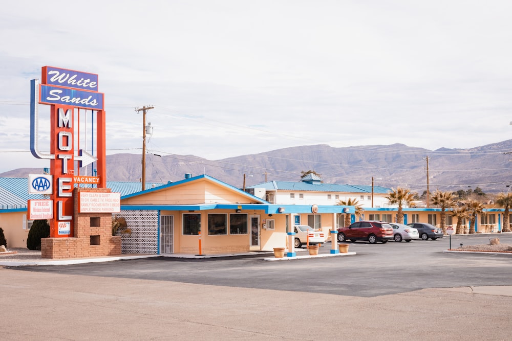 a motel with cars parked in front of it