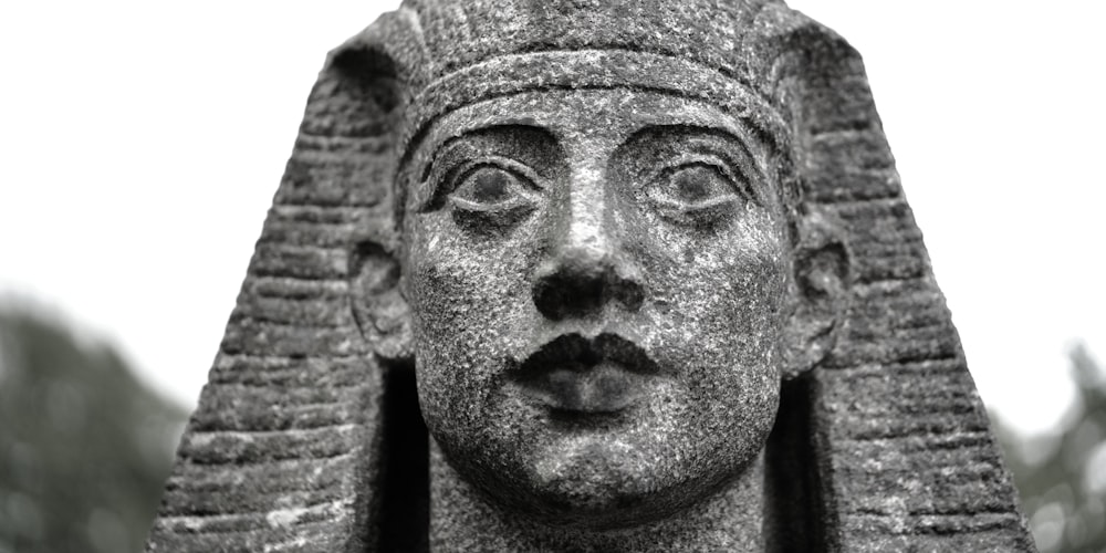 a black and white photo of a statue of a pharaoh