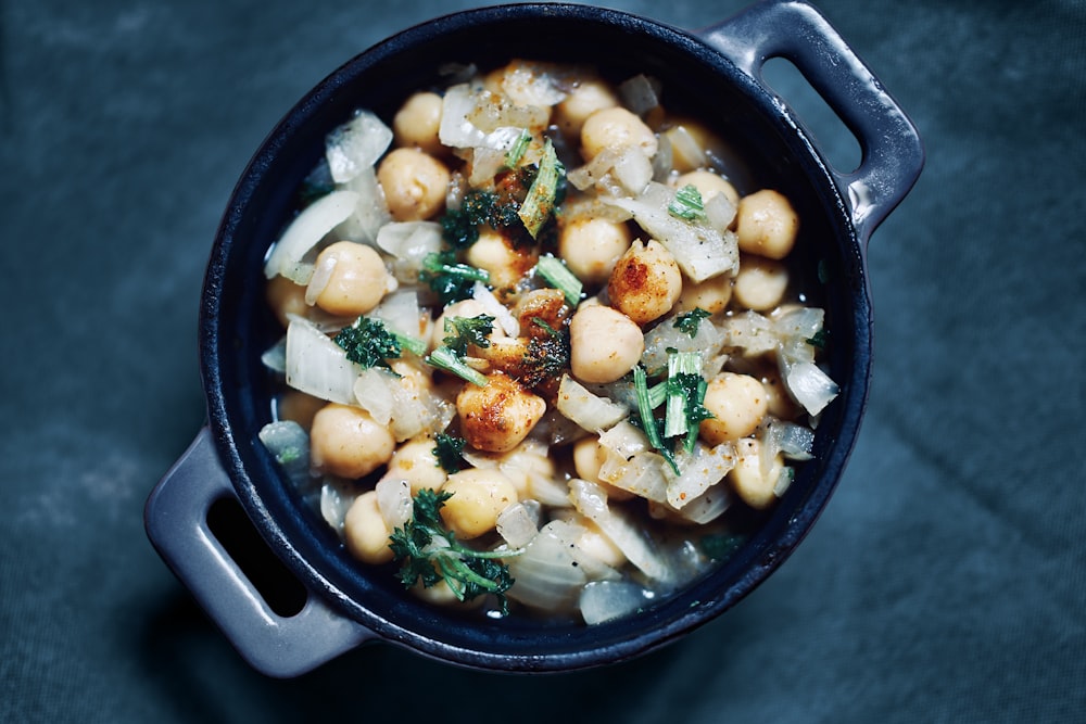 a bowl of food with broccoli and chickpeas