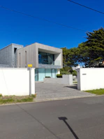 Finished exterior view of a 70 m² house prototype with clean lines and natural light.