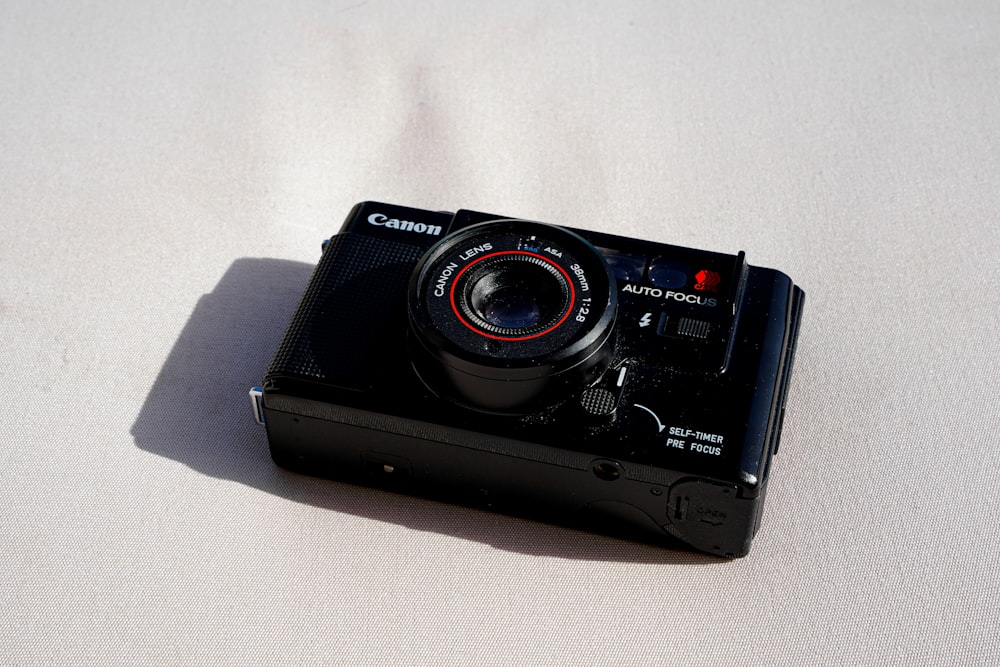 a camera sitting on top of a white surface