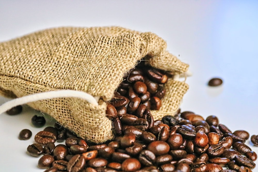 a bag of coffee beans spilling out of it