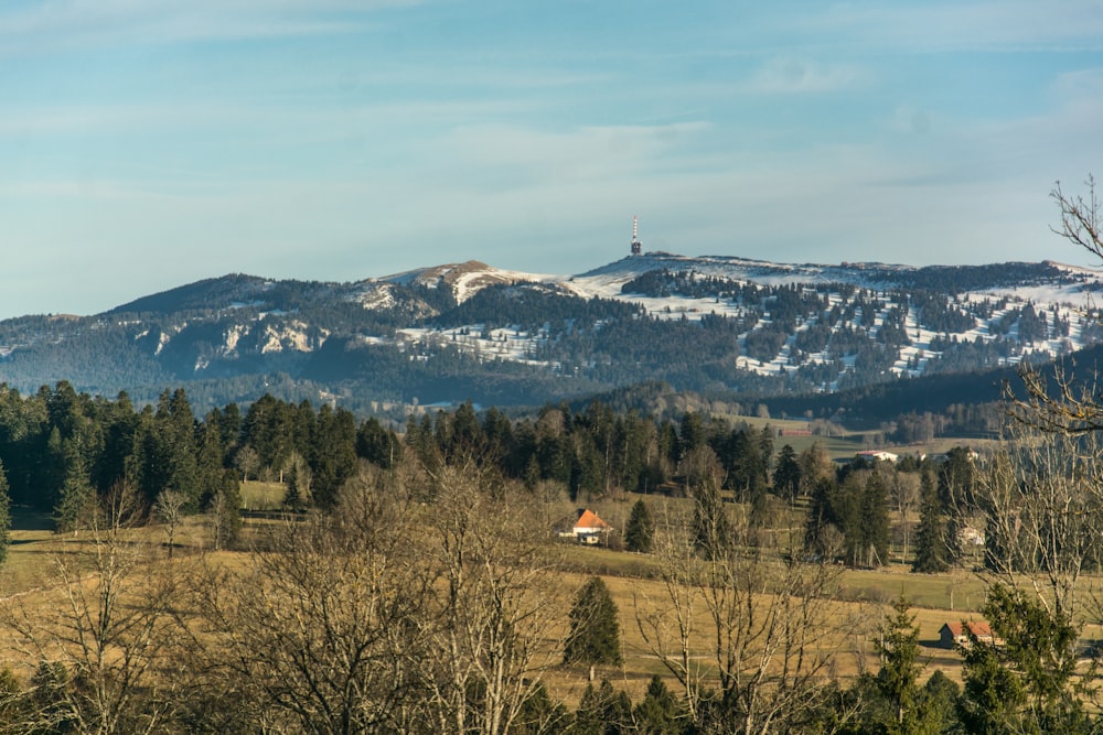 a view of a mountain range with a house in the foreground