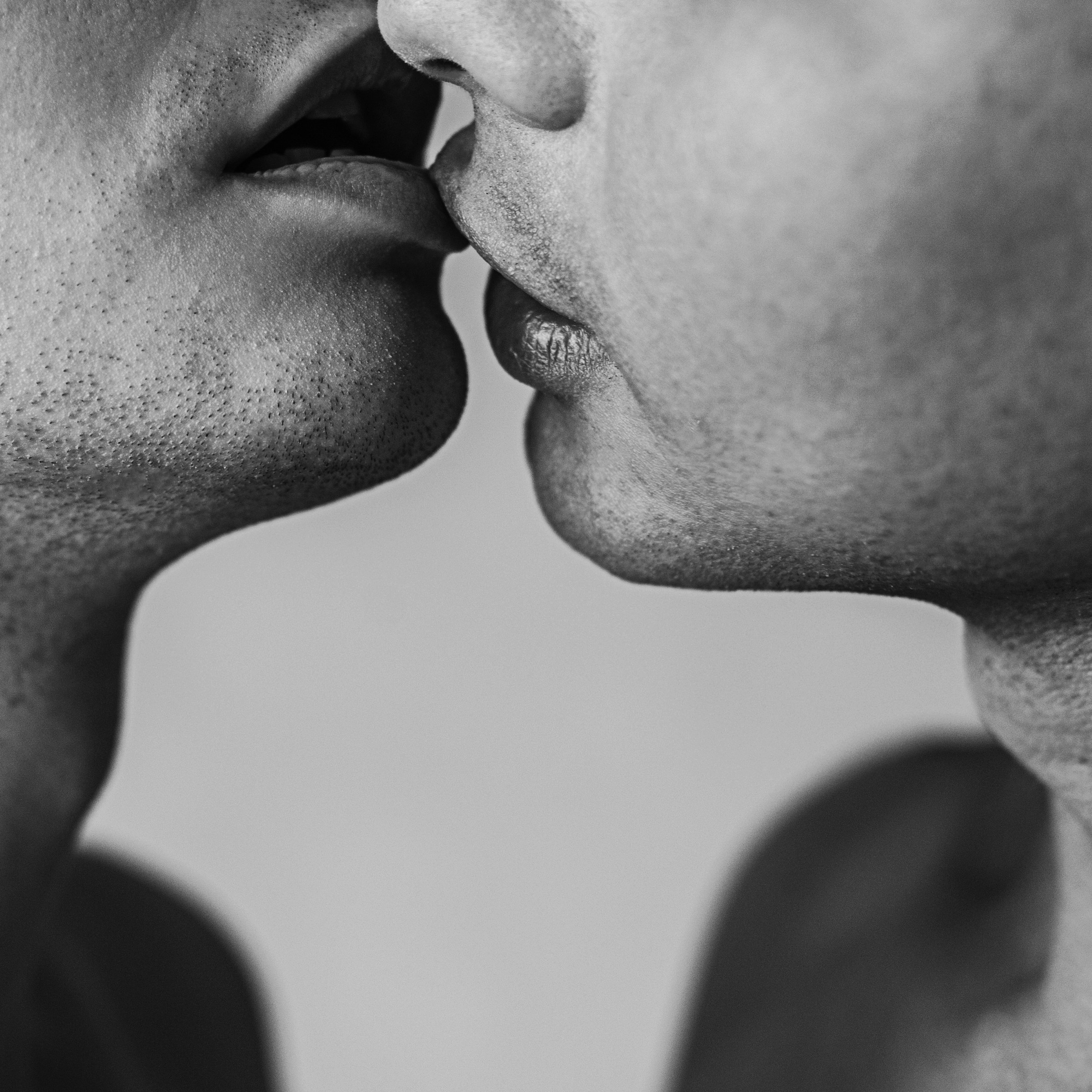 a man and a woman kissing each other