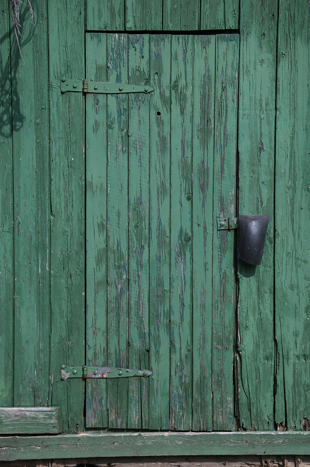 a green door with a black handle on it