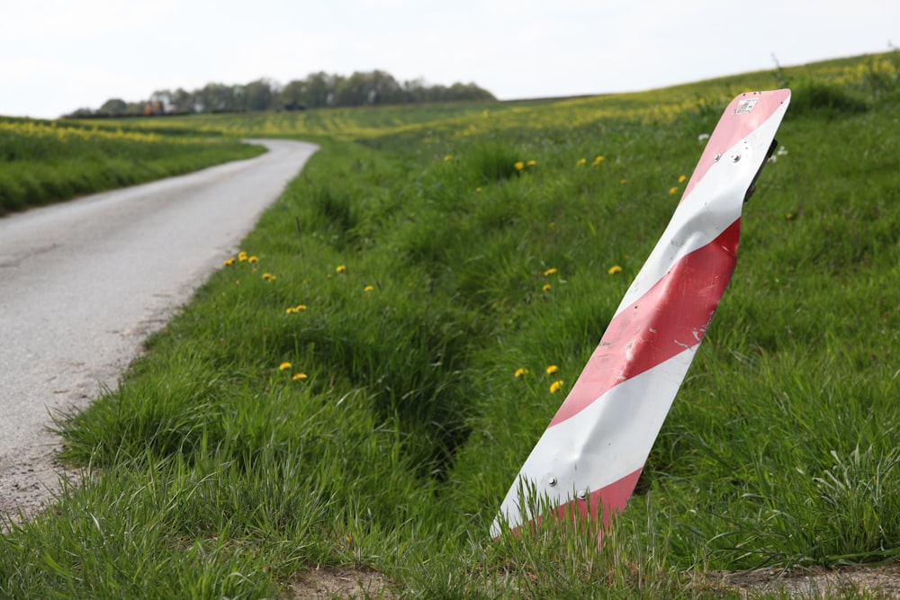 a red and white traffic sign sitting on the side of a road