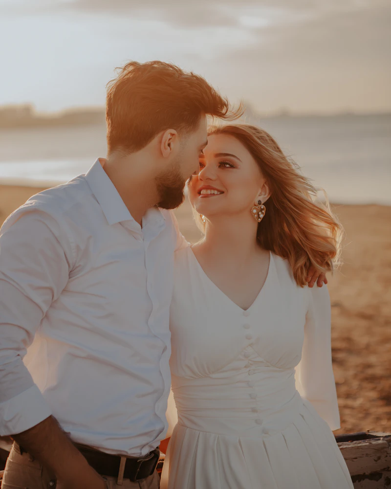 Couple sharing a laugh during golden hour engagement shoot