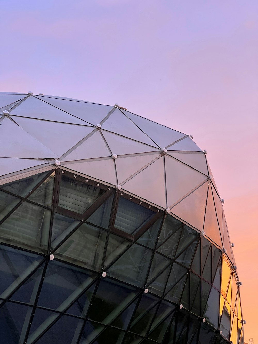 a close up of a building with a sky in the background