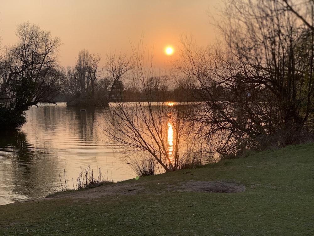 the sun is setting over a body of water