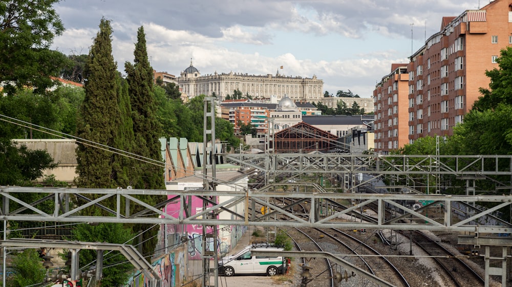 a train traveling down train tracks next to tall buildings