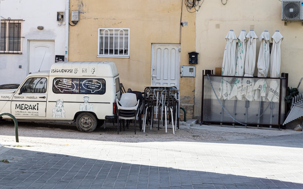 a white van parked in front of a building