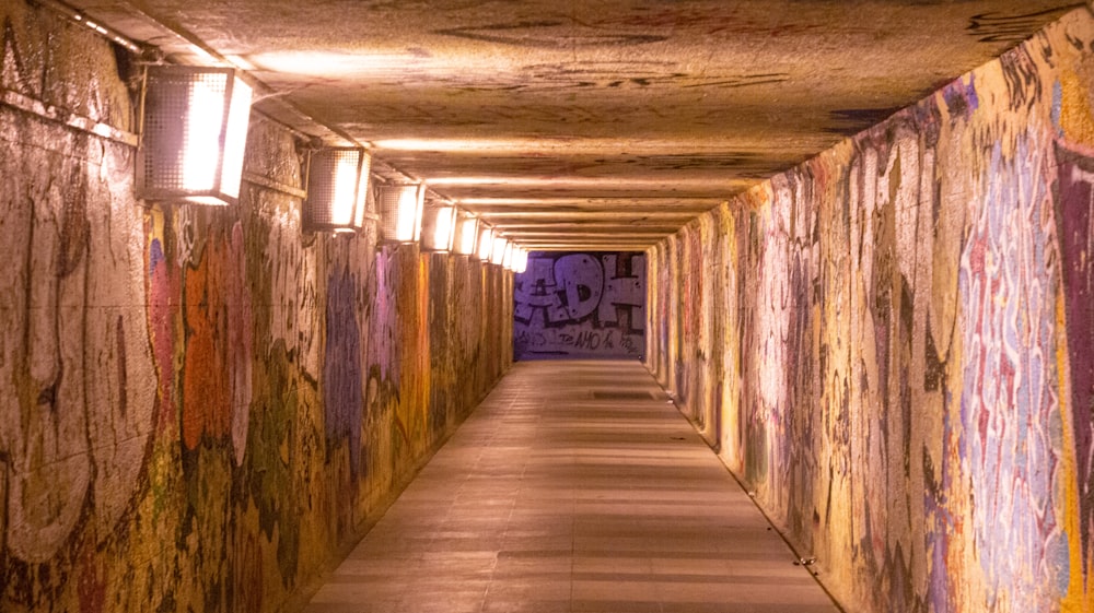 a long hallway with graffiti all over the walls