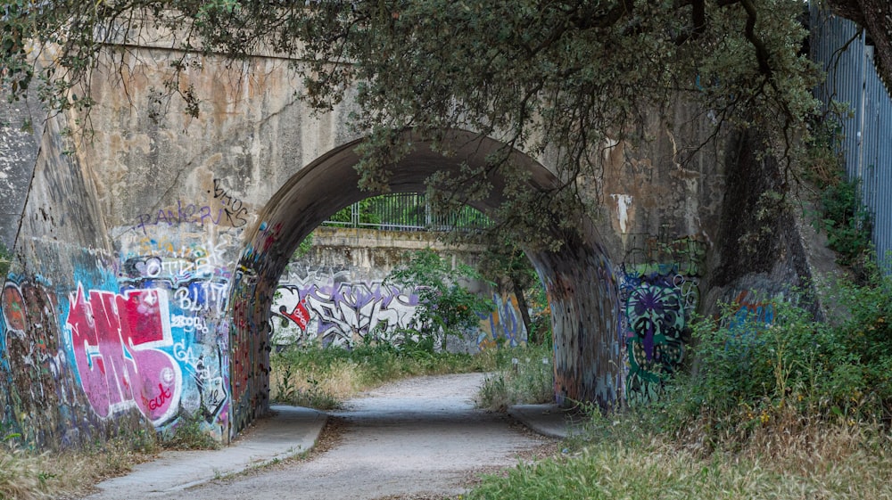 a tunnel with graffiti on the side of it