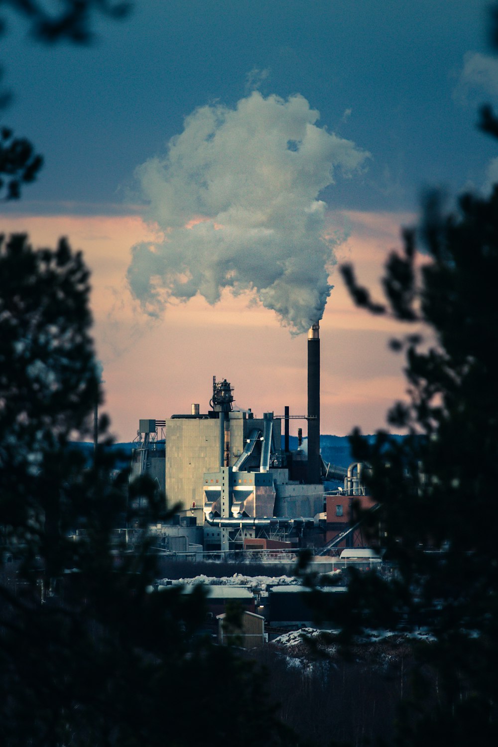 a factory with smoke coming out of it's stacks