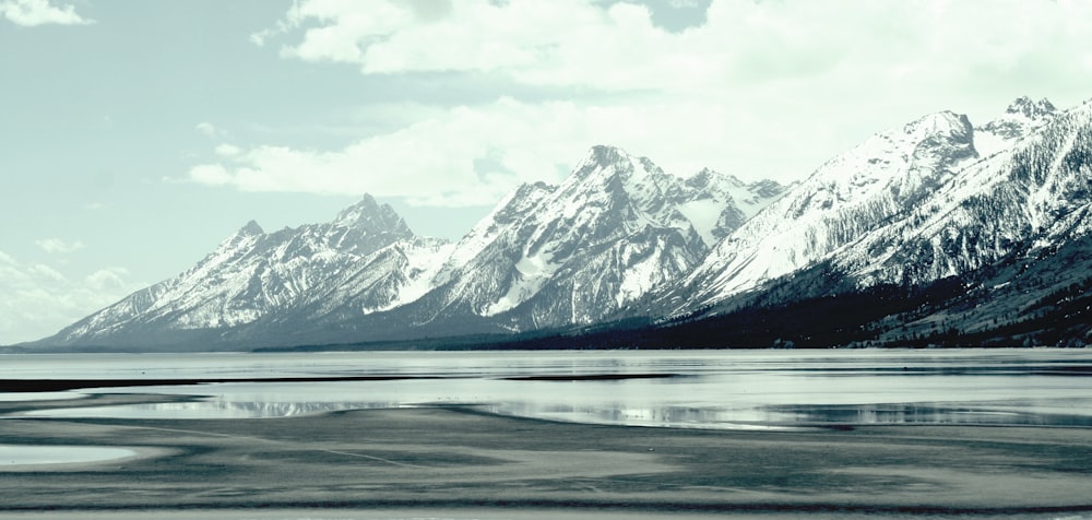 a mountain range with a body of water in front of it