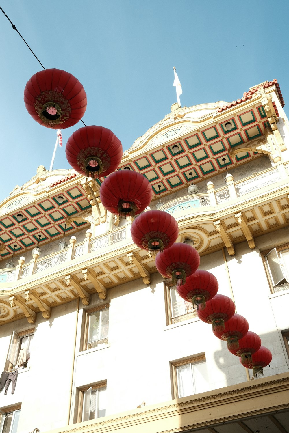 a building with red lanterns hanging from it's roof